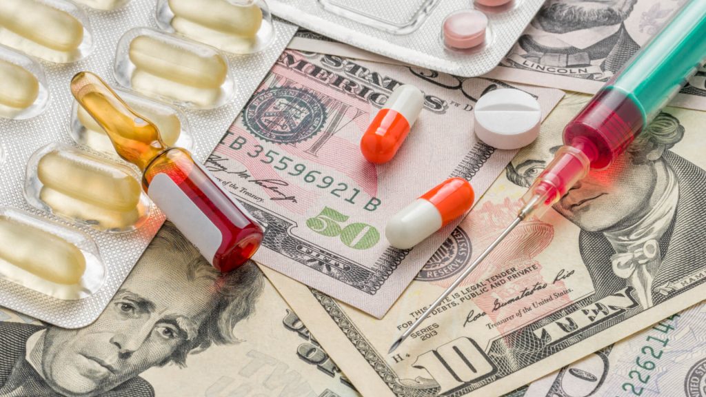 drug capsules onto of large bills